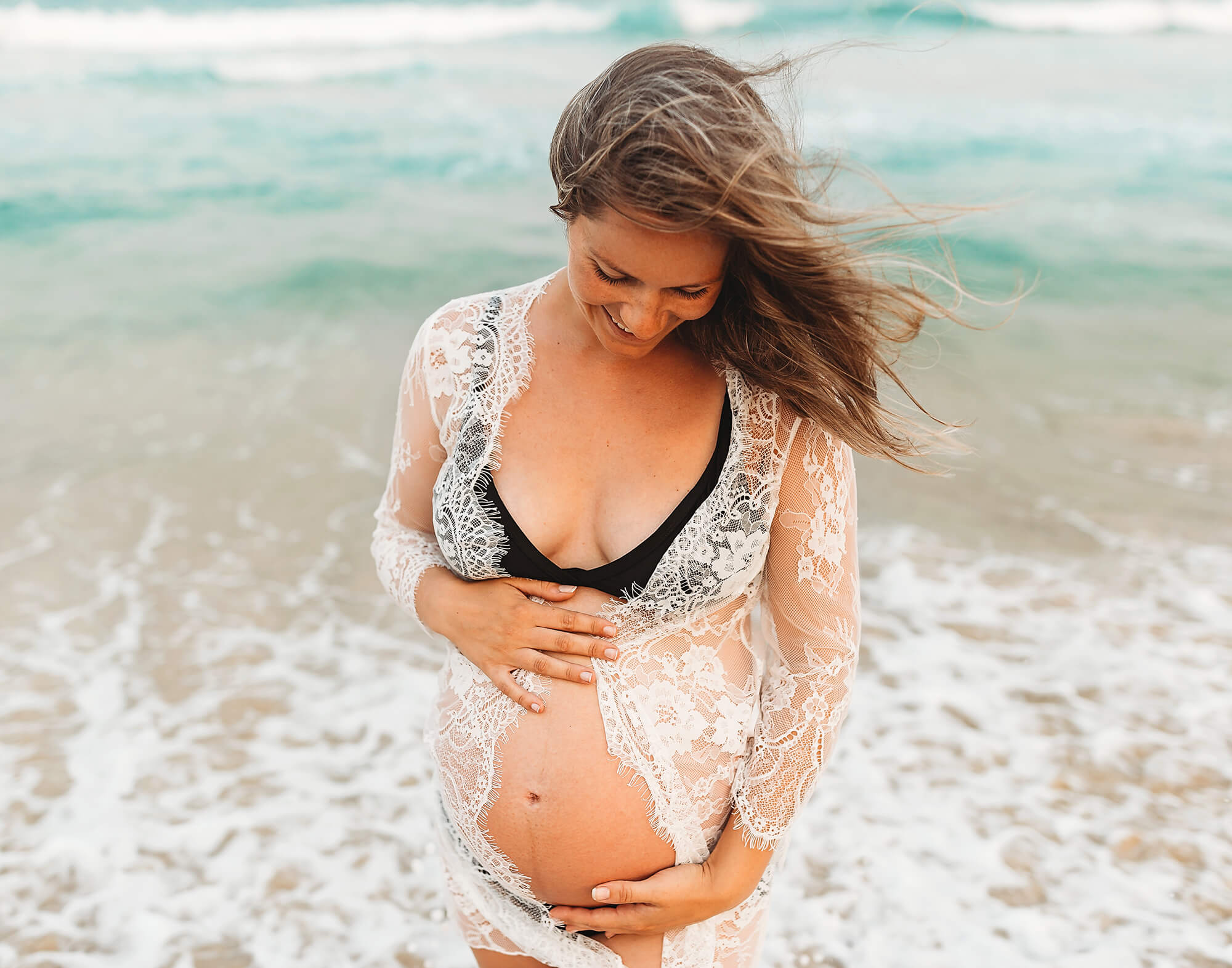 Maternity Photography Sunshine Coast | pregnant mum wearing a lace maternity gown standing in water at a sunshine coast beach